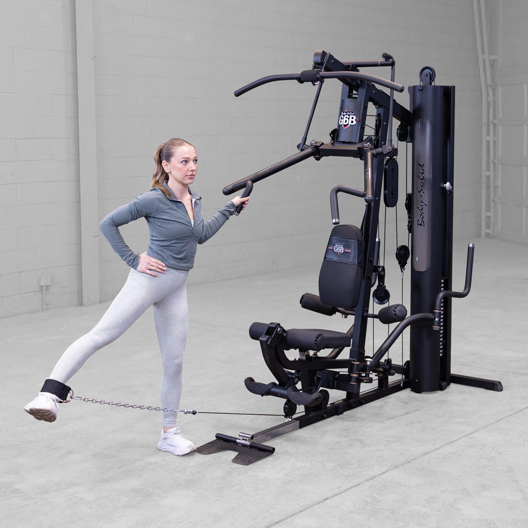 Body-Solid G6B gym in use with standing leg abduction