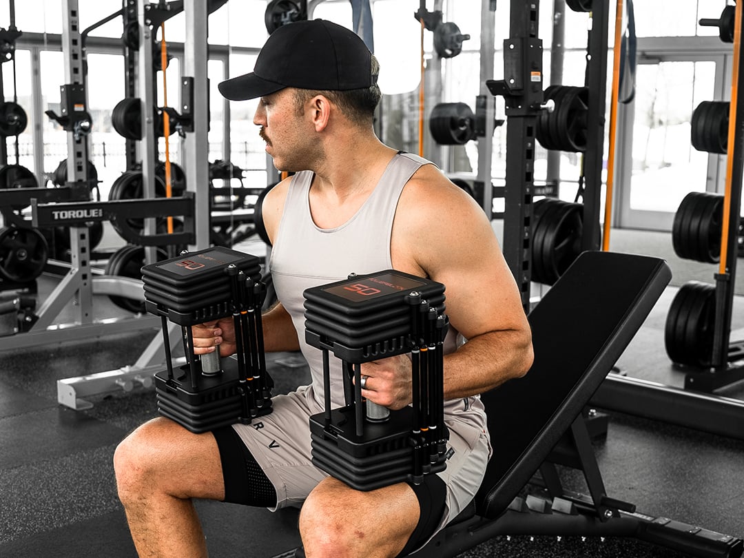 PowerBlock Commercial Pro 100 Set 5-100 lbs w/ Stand PowerBlock Dumbbells commercial-pro-100-_750-00309-00_lifestyle-bench