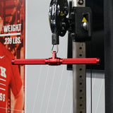 Gronk Fitness red revolving straight bar in use on a cable machine