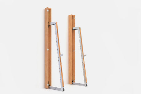 Two wall-mounted squat racks in warm golden wood, one folded shut and one opened to a silver ladder
