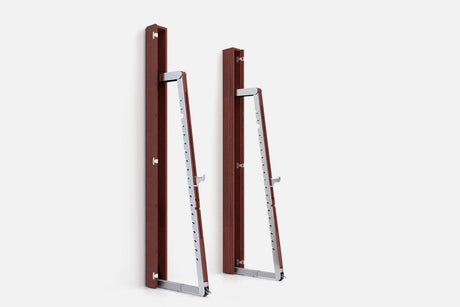 Two wall-mounted squat racks in dark reddish-brown wood, one folded shut and one opened to a silver ladder