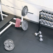 SuperMats MuscleMat in gym setting with weights
